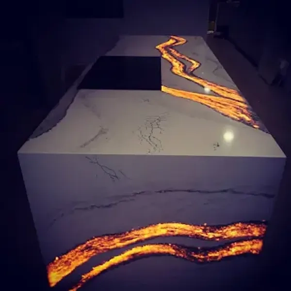 White marble kitchen island with glowing orange resin veins.